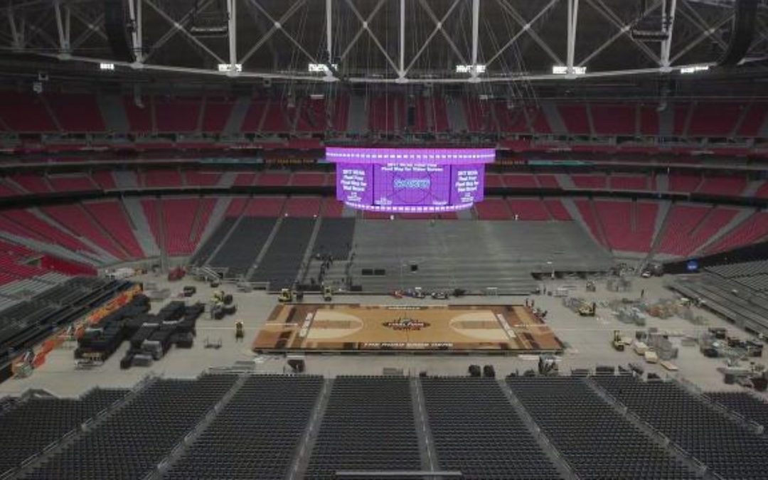 Piece by piece, the court for the NCAA Final Four tournament is put together in Glendale
