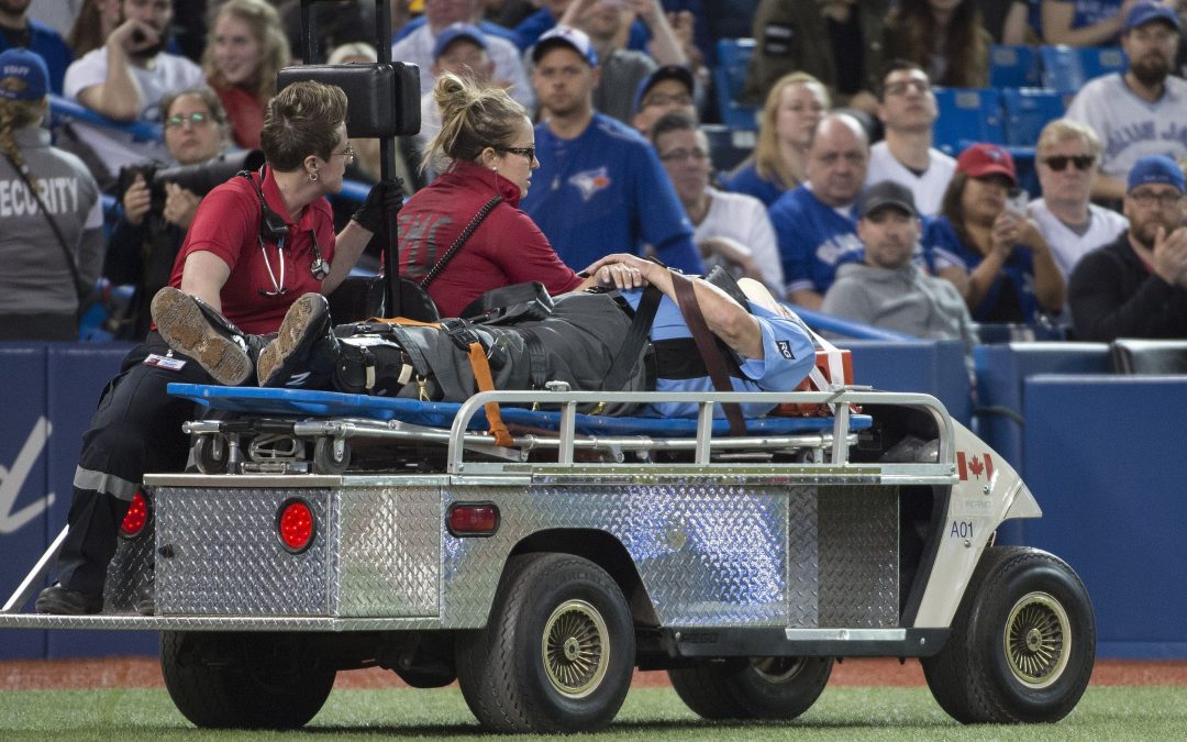 Umpire Dale Scott stretchered off field after being struck in mask by foul tip
