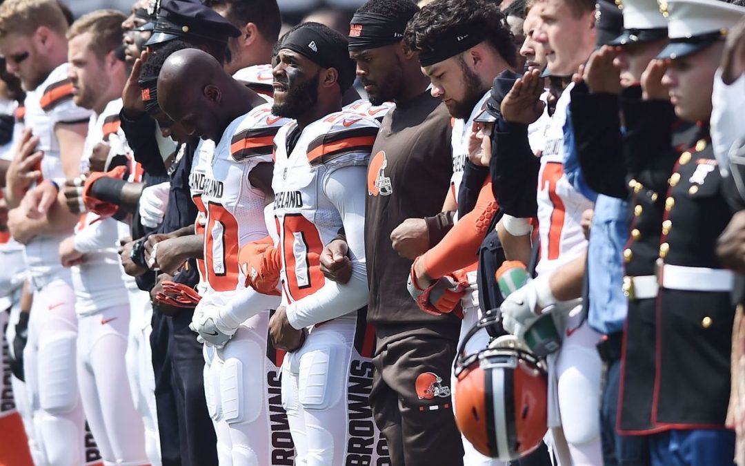 Browns players stand with police for national anthem