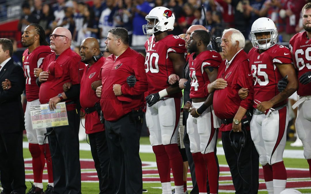 NFL players lock arms in national anthem at Cowboys-Cardinals game