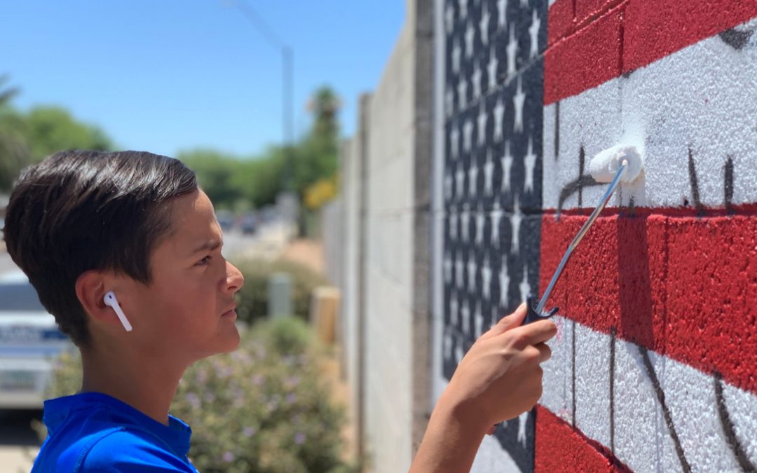 Phoenix police officers repaint defaced American flag mural